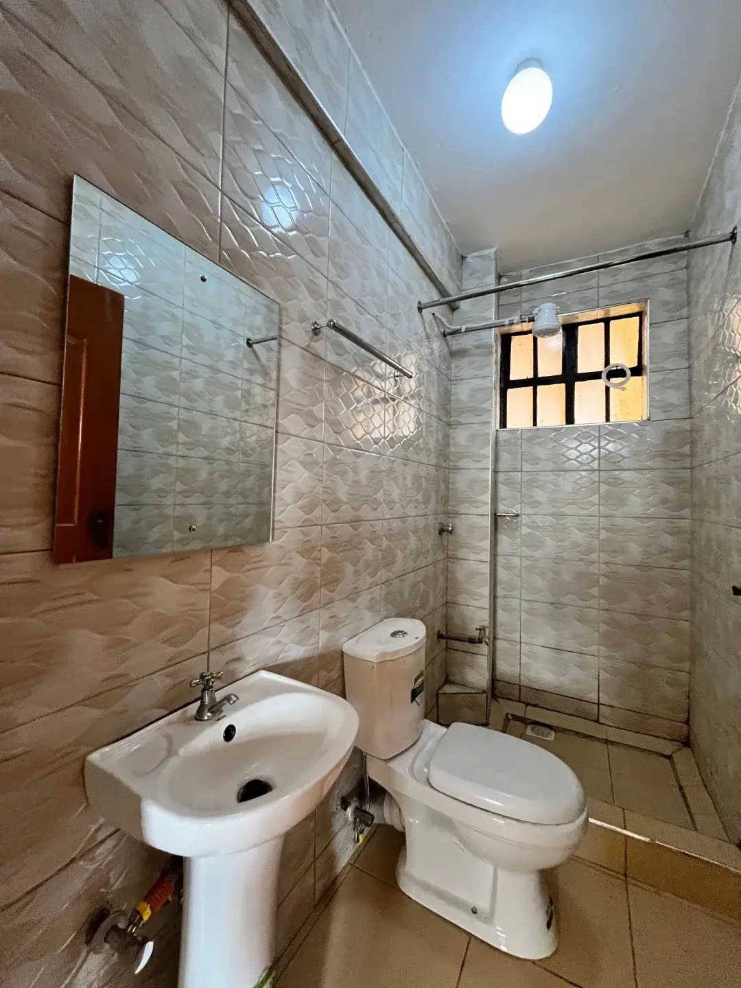 Modern bathroom with glass shower enclosure and pedestal sink