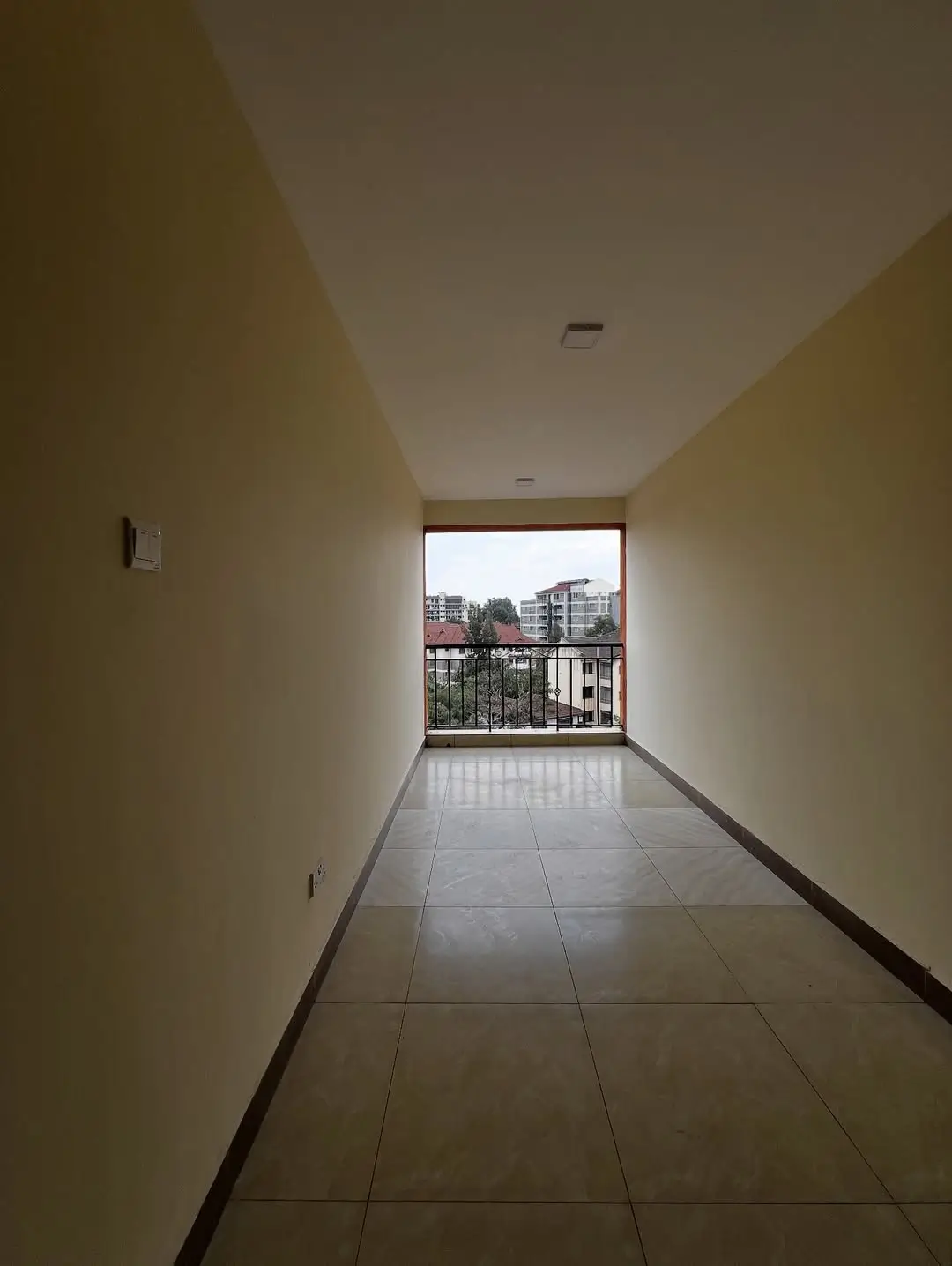 Spacious balcony with city views and tiled flooring