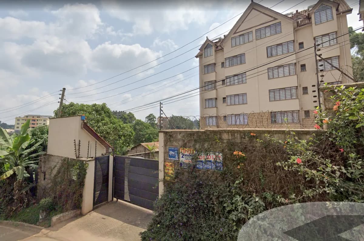 Multi-story residential building with gated compound entrance
