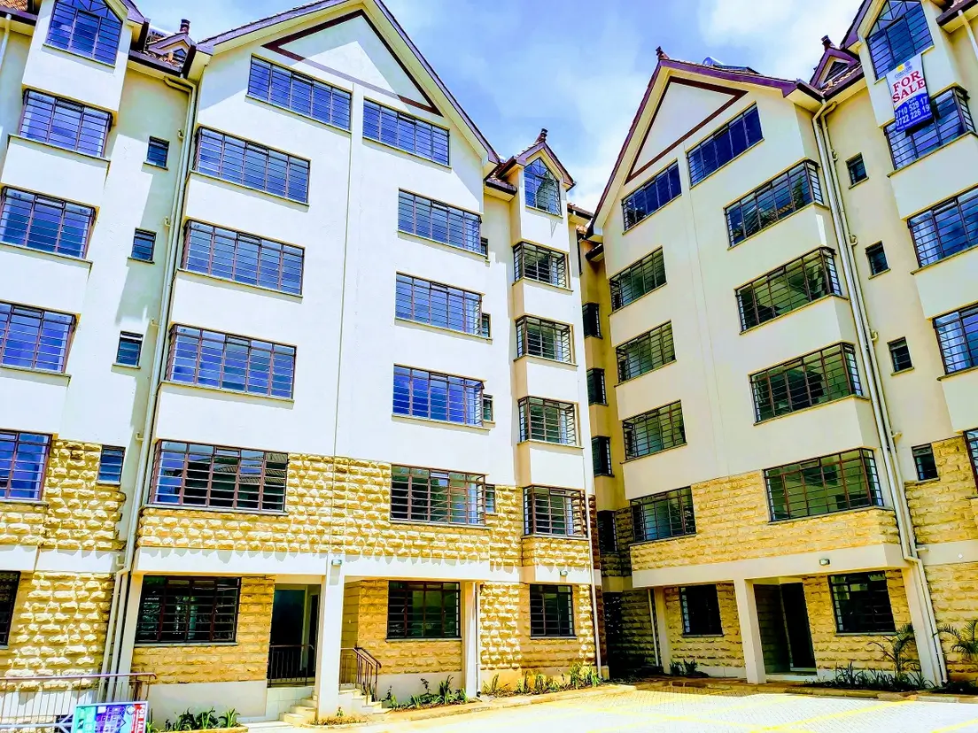 Multi-story residential building with yellow brick and white facade