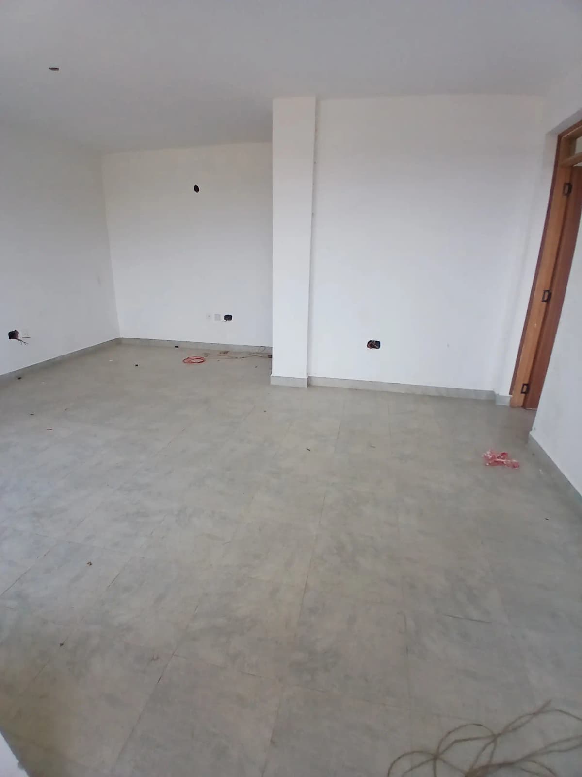 Unfinished interior space with concrete flooring and bare walls