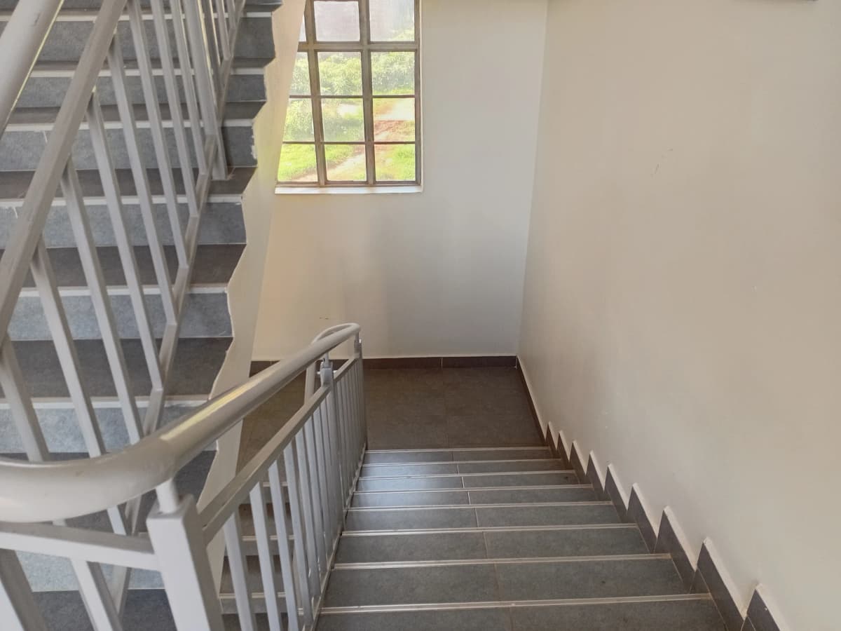 Internal staircase with metal railings and natural light