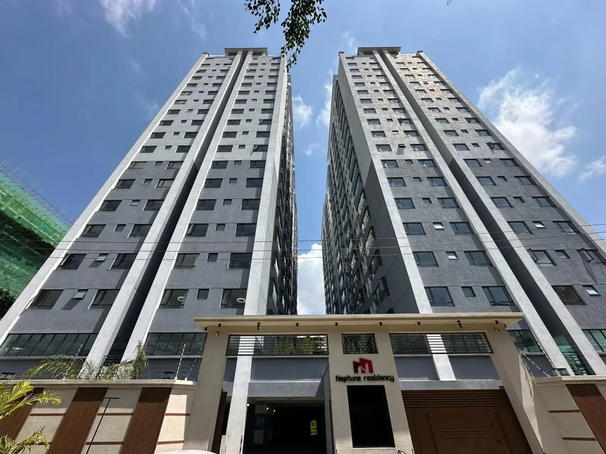 Modern multi-story residential tower with ground floor entrance lobby