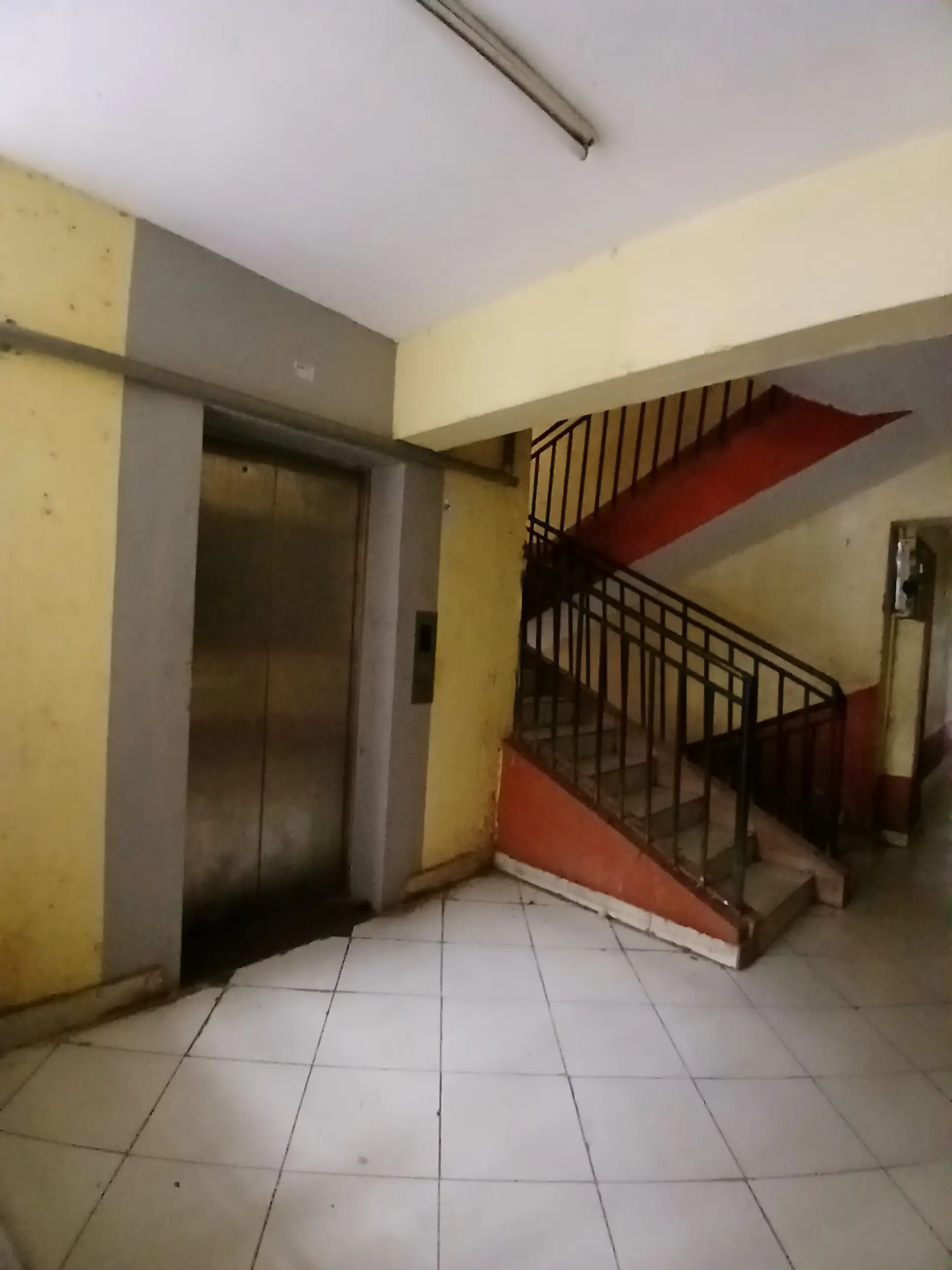 Building lobby with elevator and internal staircase access