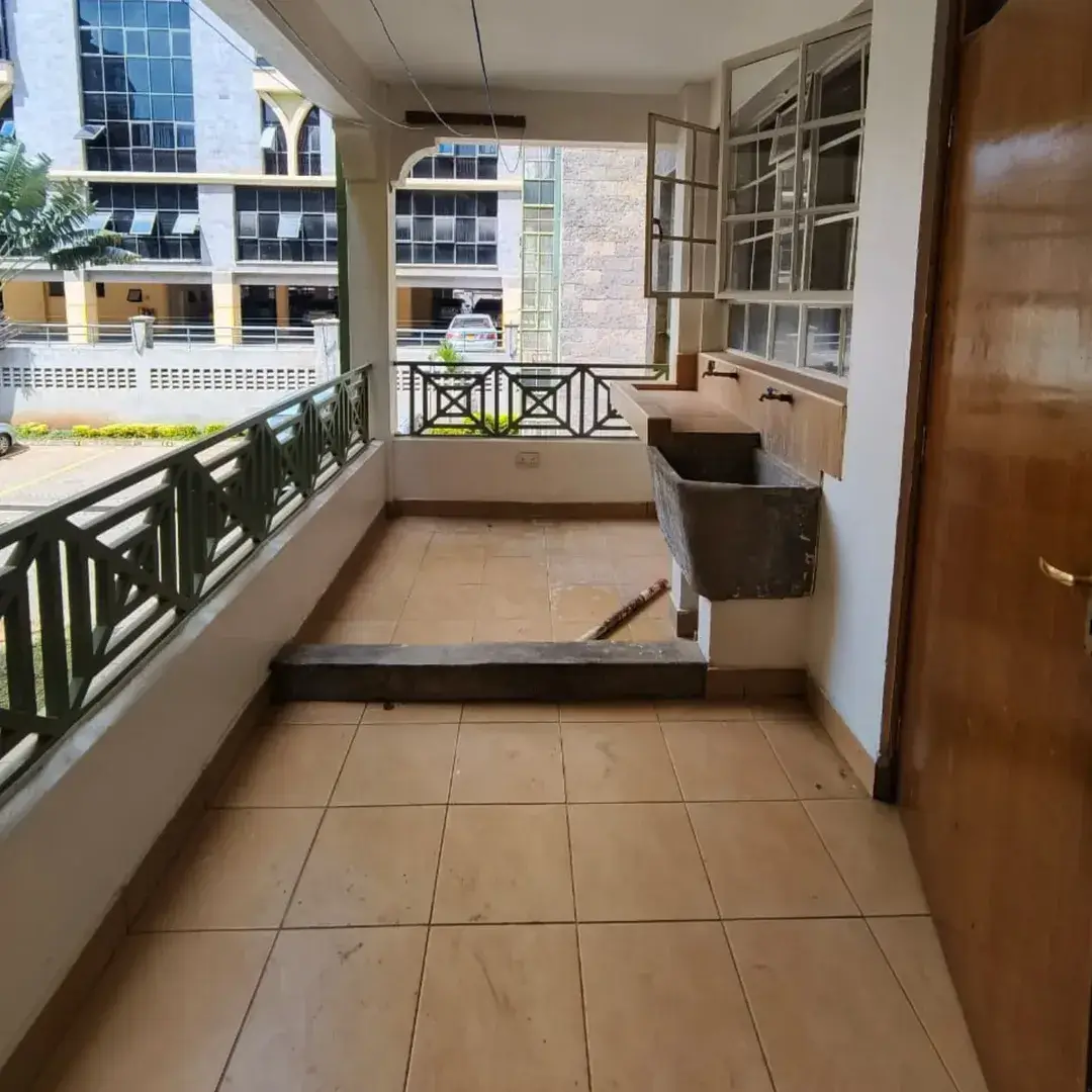 Spacious balcony with laundry hanging area and city view