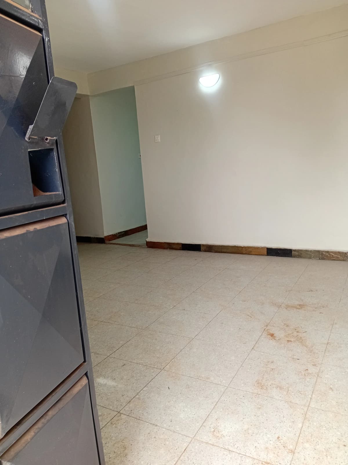 Compact kitchen with stainless steel appliances and tile flooring