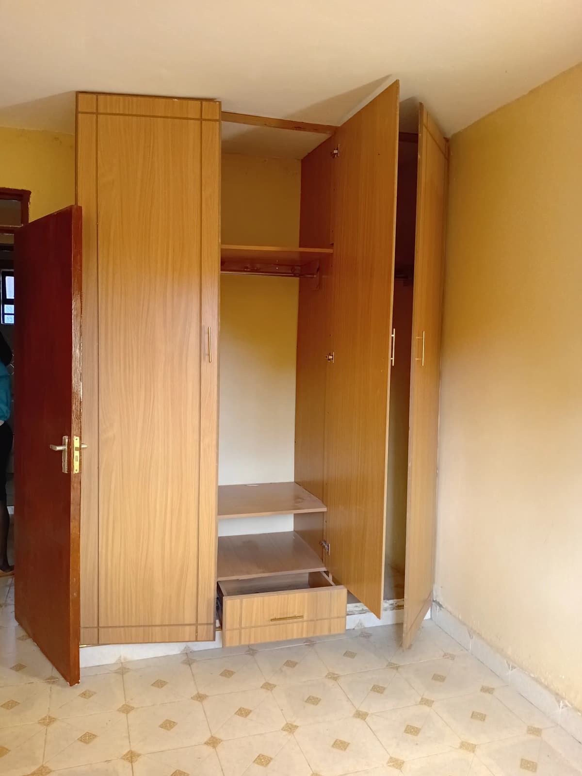 Bedroom with open wooden wardrobe and storage shelving