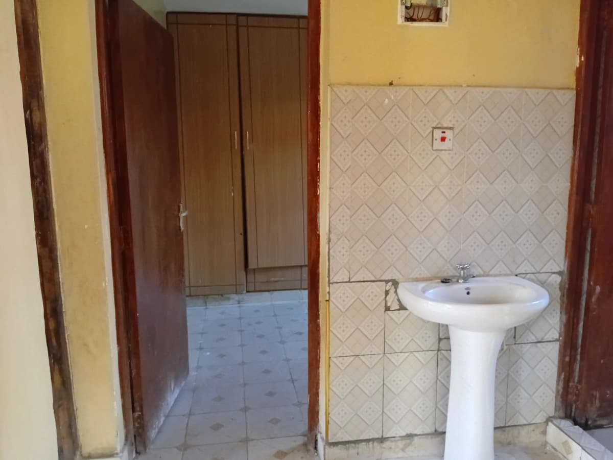 Basic bathroom with pedestal sink and tiled walls
