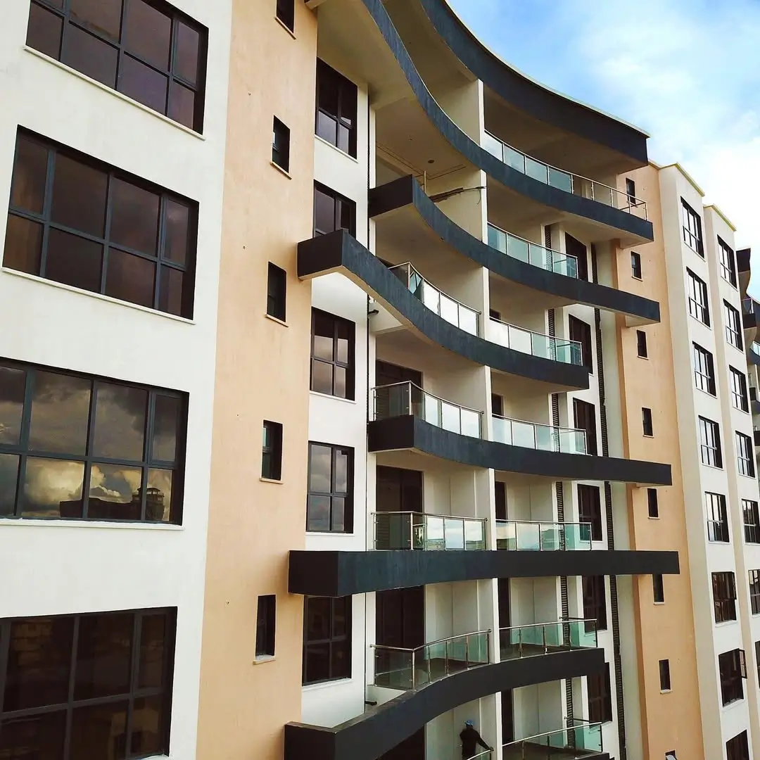 Modern multi-story residential building facade with curved balconies