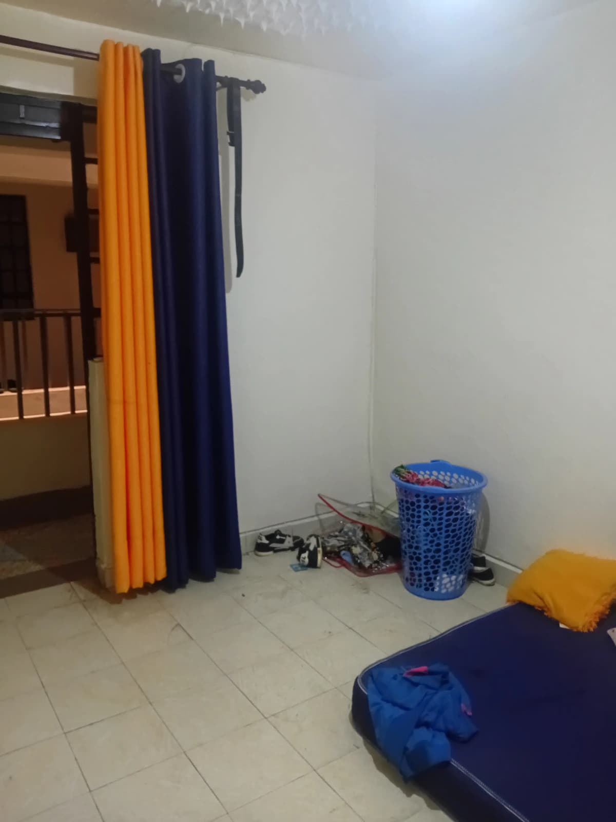 Unfurnished bedroom with curtain rods and moving boxes