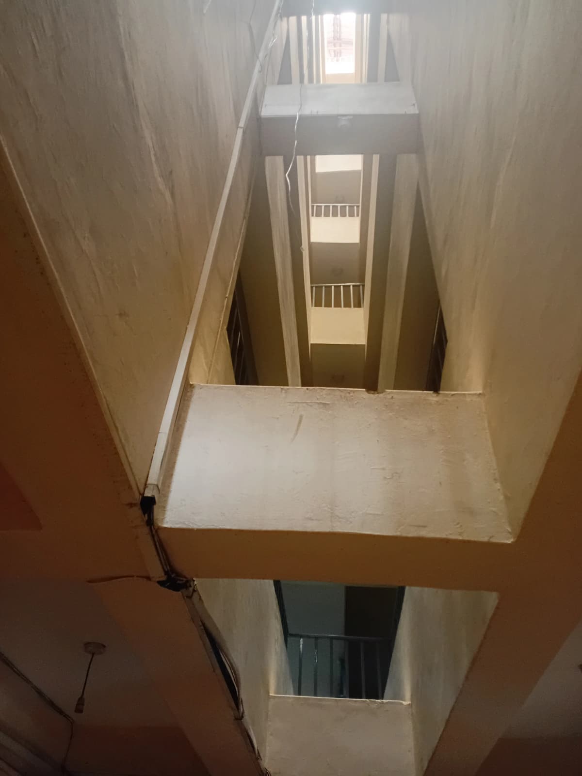 Multi-level interior stairwell with natural light from windows