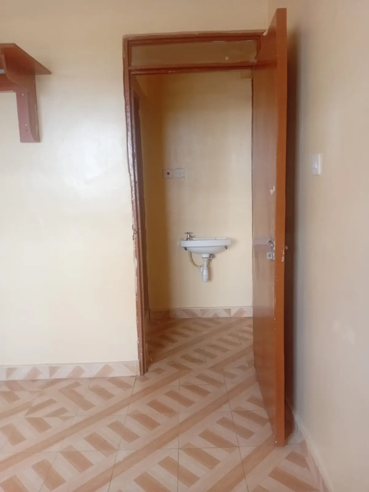 Wall-mounted sink and herringbone tile floor