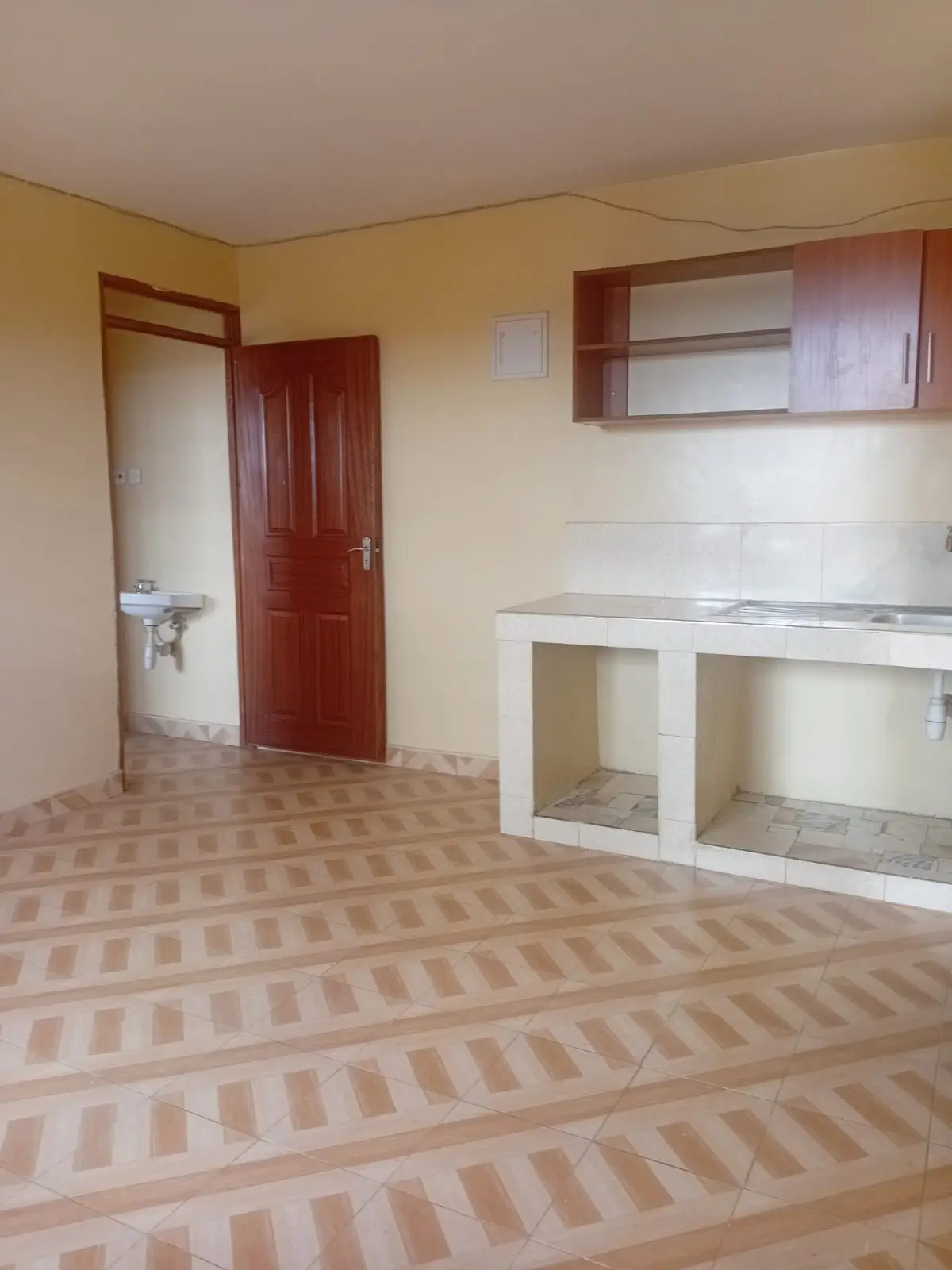 Empty kitchen with counter space and overhead cabinets