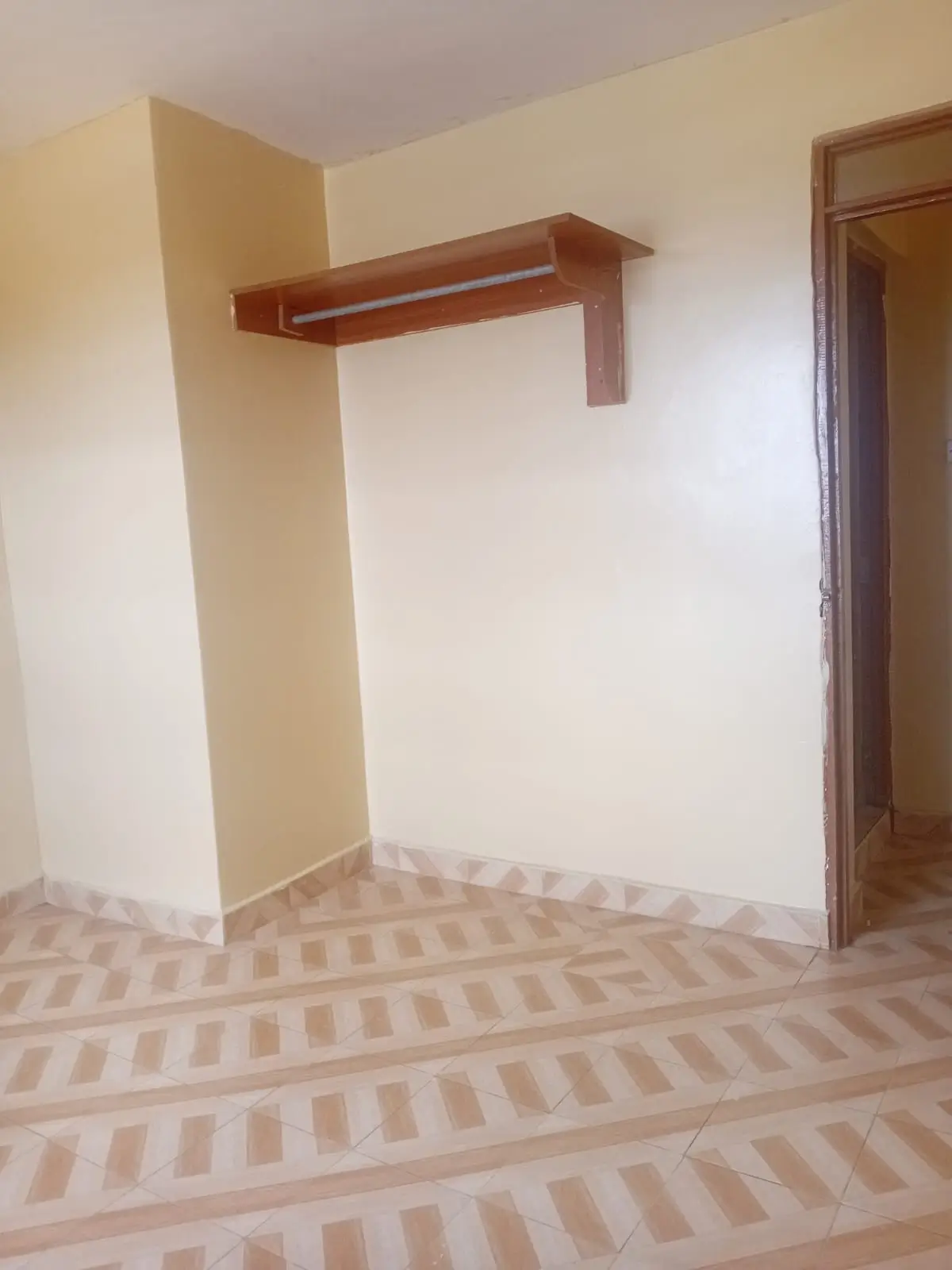 Room with wooden rail and striped flooring