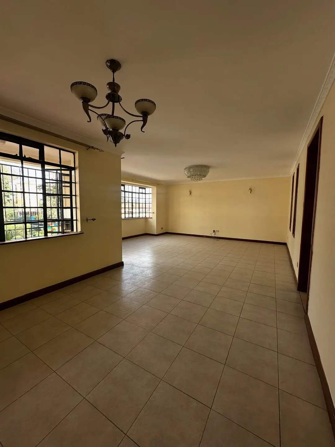 Spacious living room with tiled floors and natural light