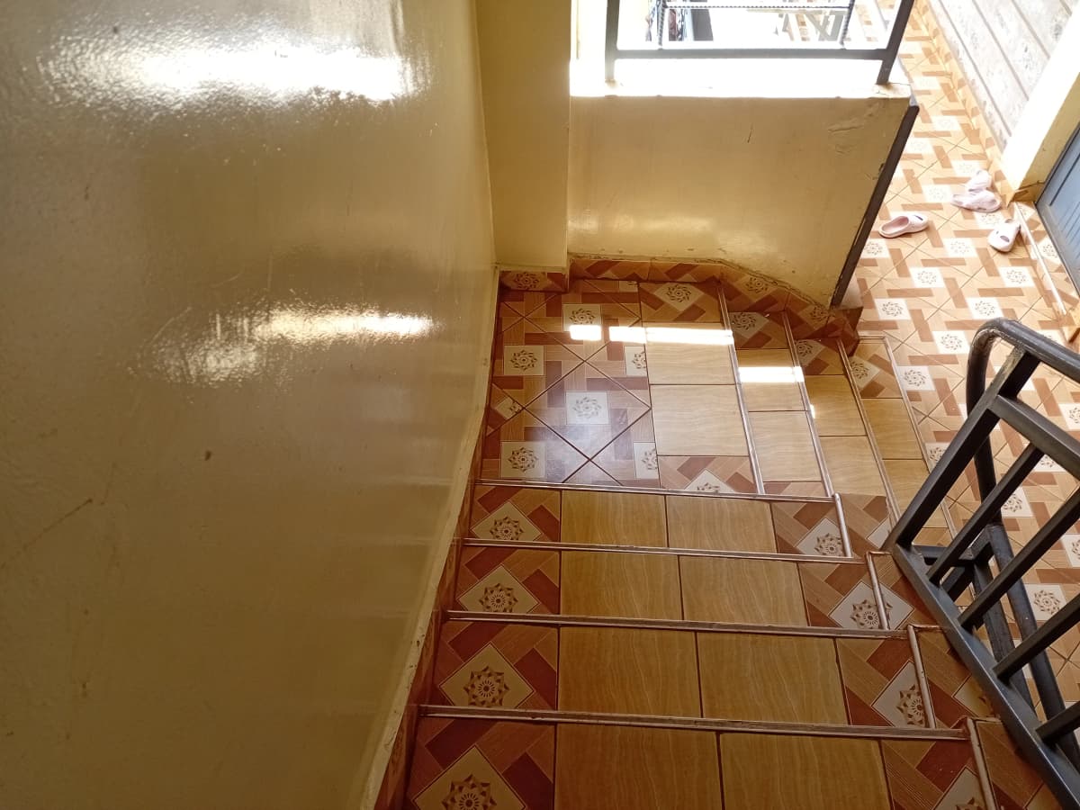 Galley kitchen with tiled flooring and natural light