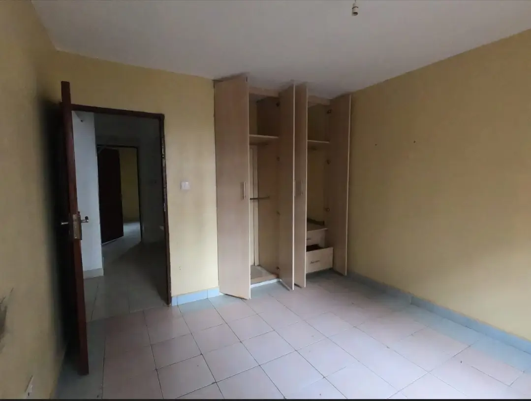 Spacious bedroom with built-in wardrobes and cream walls