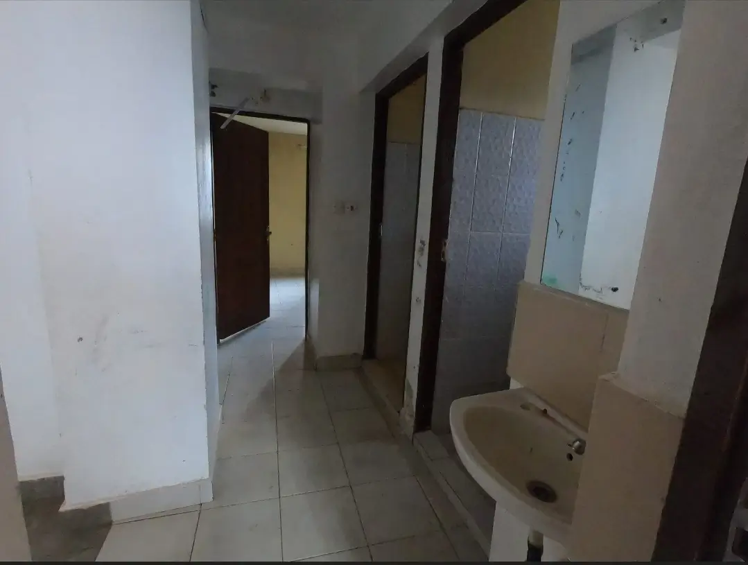 Internal hallway with multiple doors and sink fixture