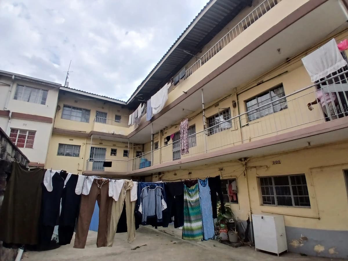 Multi-story residential building courtyard with laundry lines