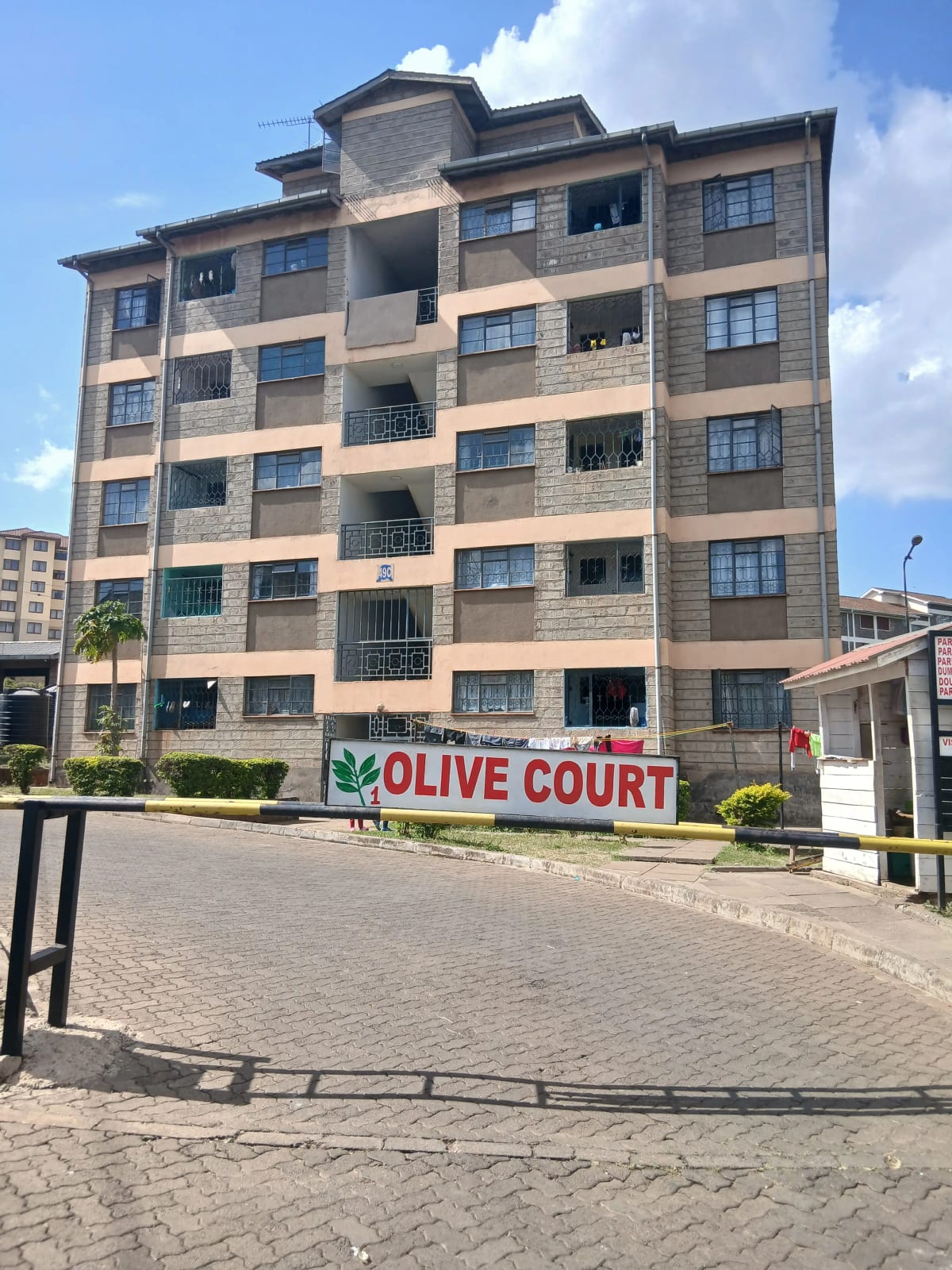 Multi-story residential building facade with balconies and signage
