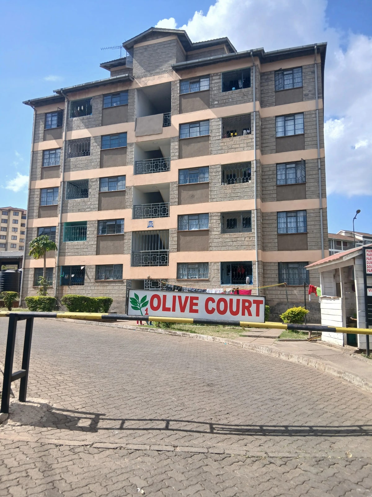 Multi-story residential building facade with balconies and signage