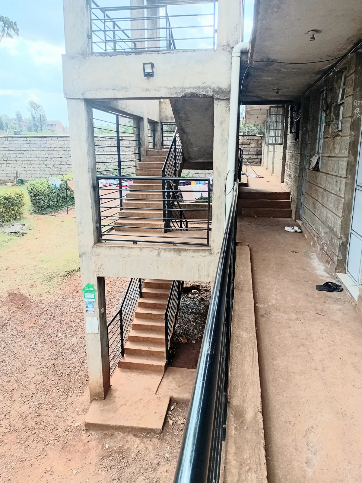 Multi-level residential building exterior with staircase and entrance