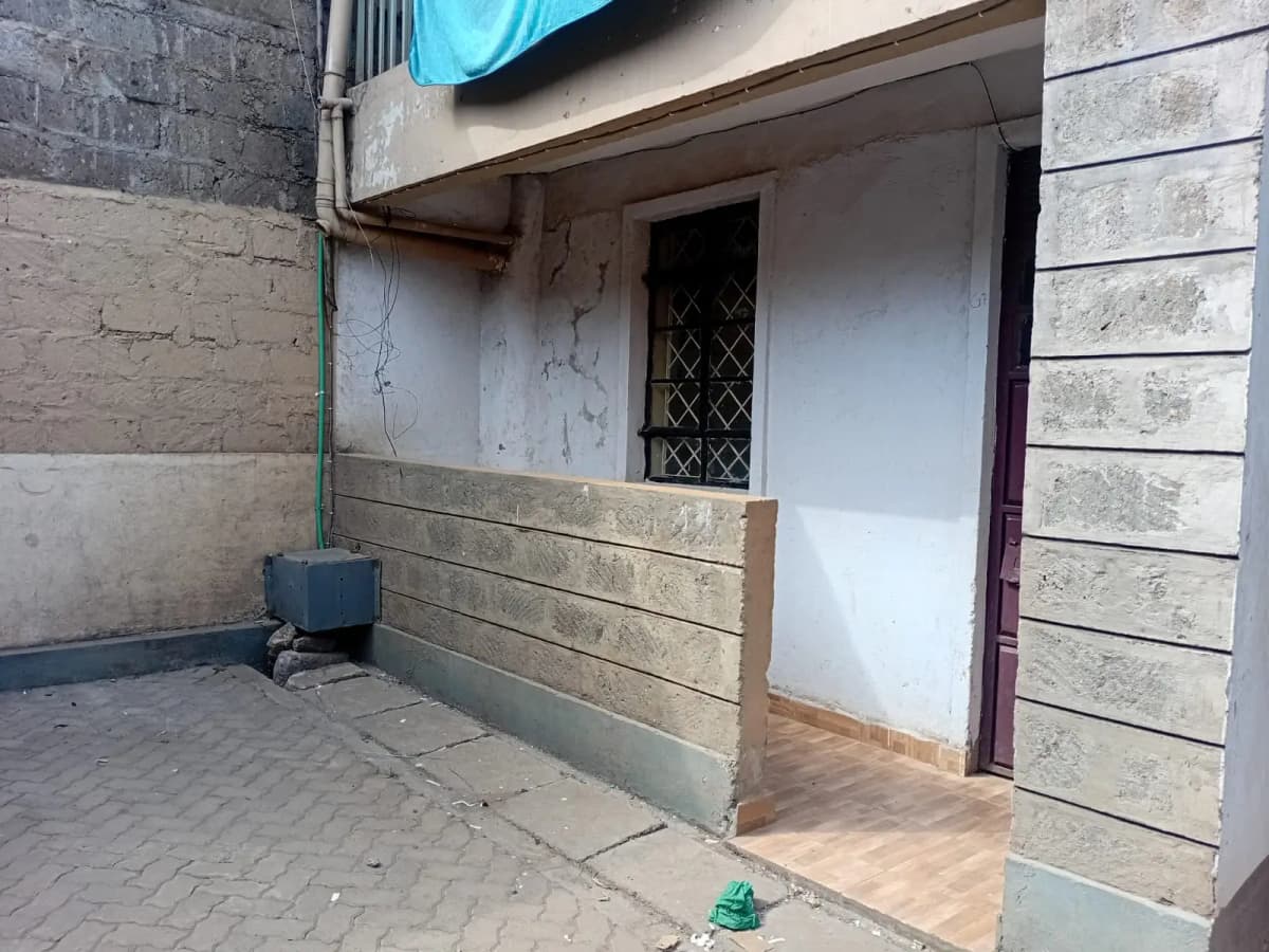 Property entrance with paved compound and wooden barrier