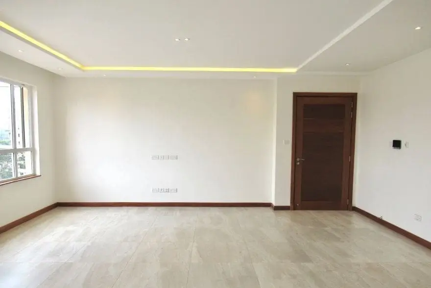 Spacious empty living room with indirect ceiling lighting