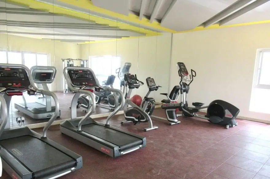 Spacious gym with treadmills, exercise bikes, and cardio equipment