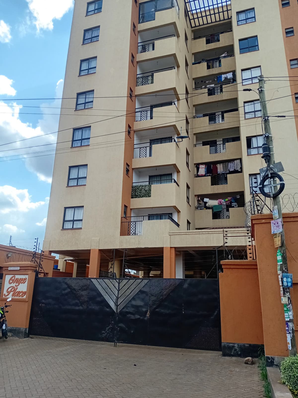 Multi-story apartment building facade with secure gate entrance