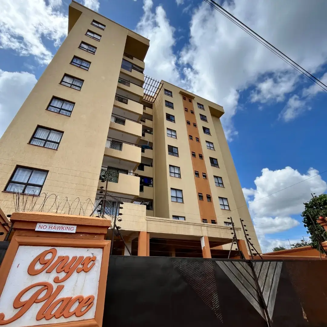 Multi-story residential building facade with balconies and entrance