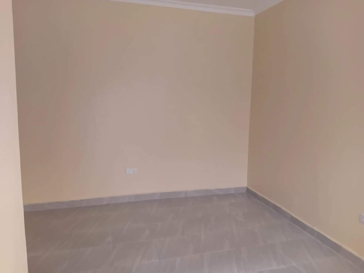 Empty bedroom with neutral walls and grey flooring