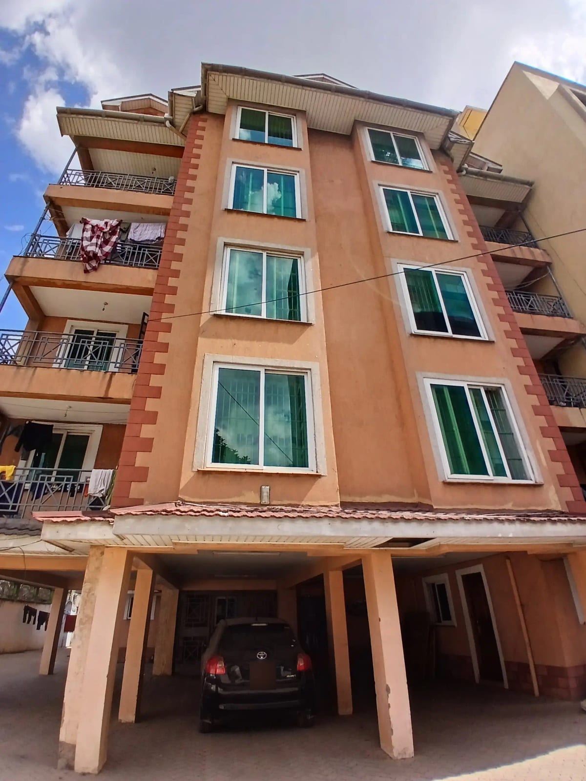 Multi-story residential building with covered parking below