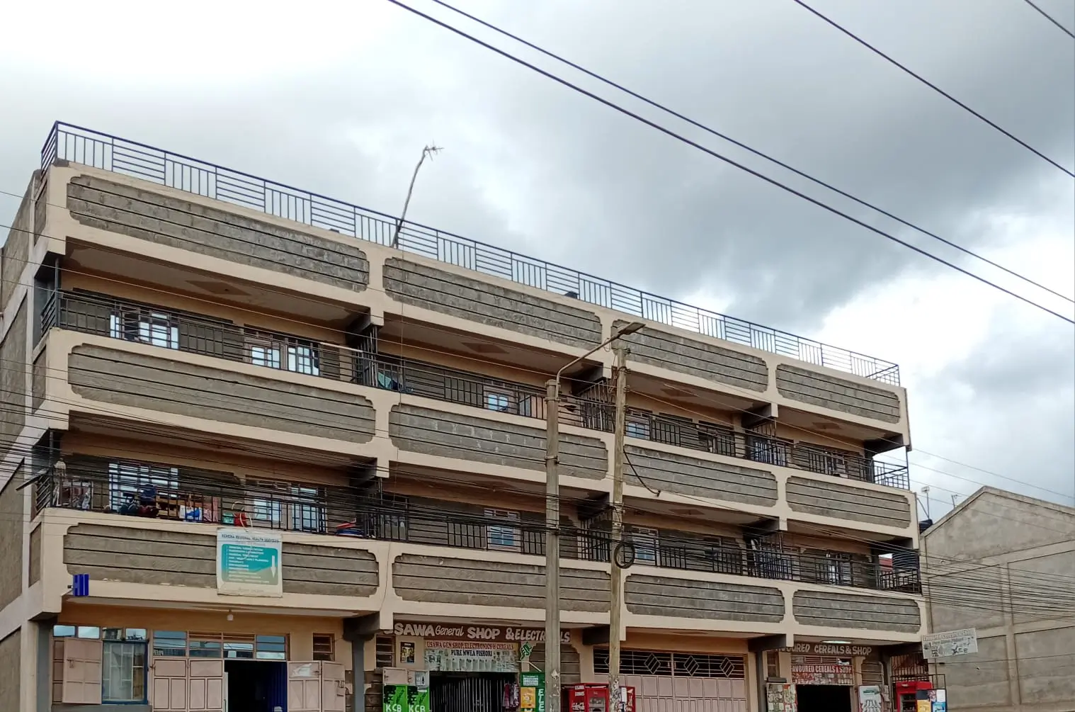 Multi-story residential building facade with retail ground floor