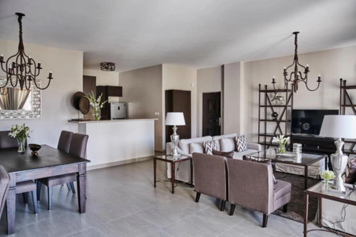 Open-plan living and dining with elegant furnishings and chandeliers