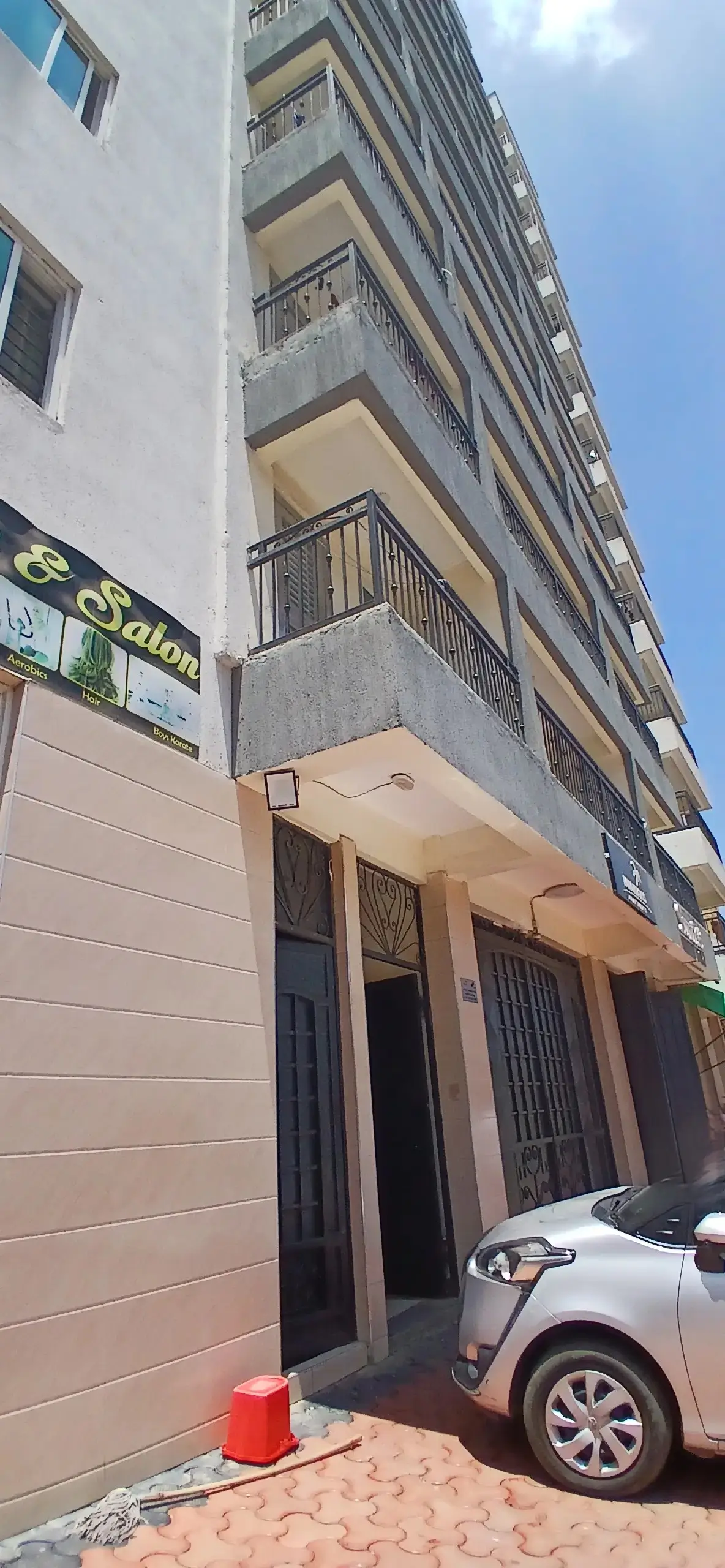 Multi-story residential building facade with ground-level commercial space