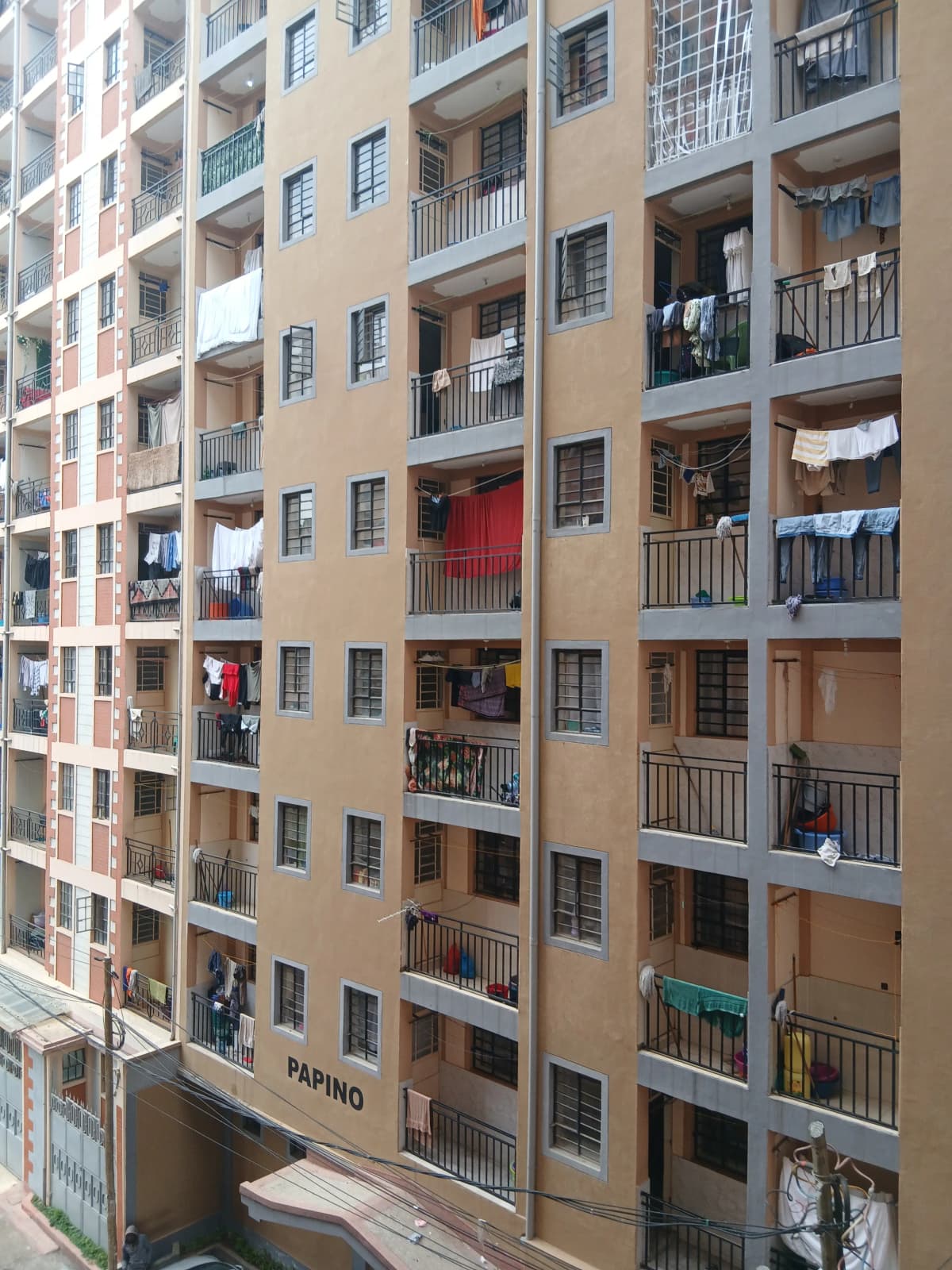 Multi-story residential building facade with balconies and laundry