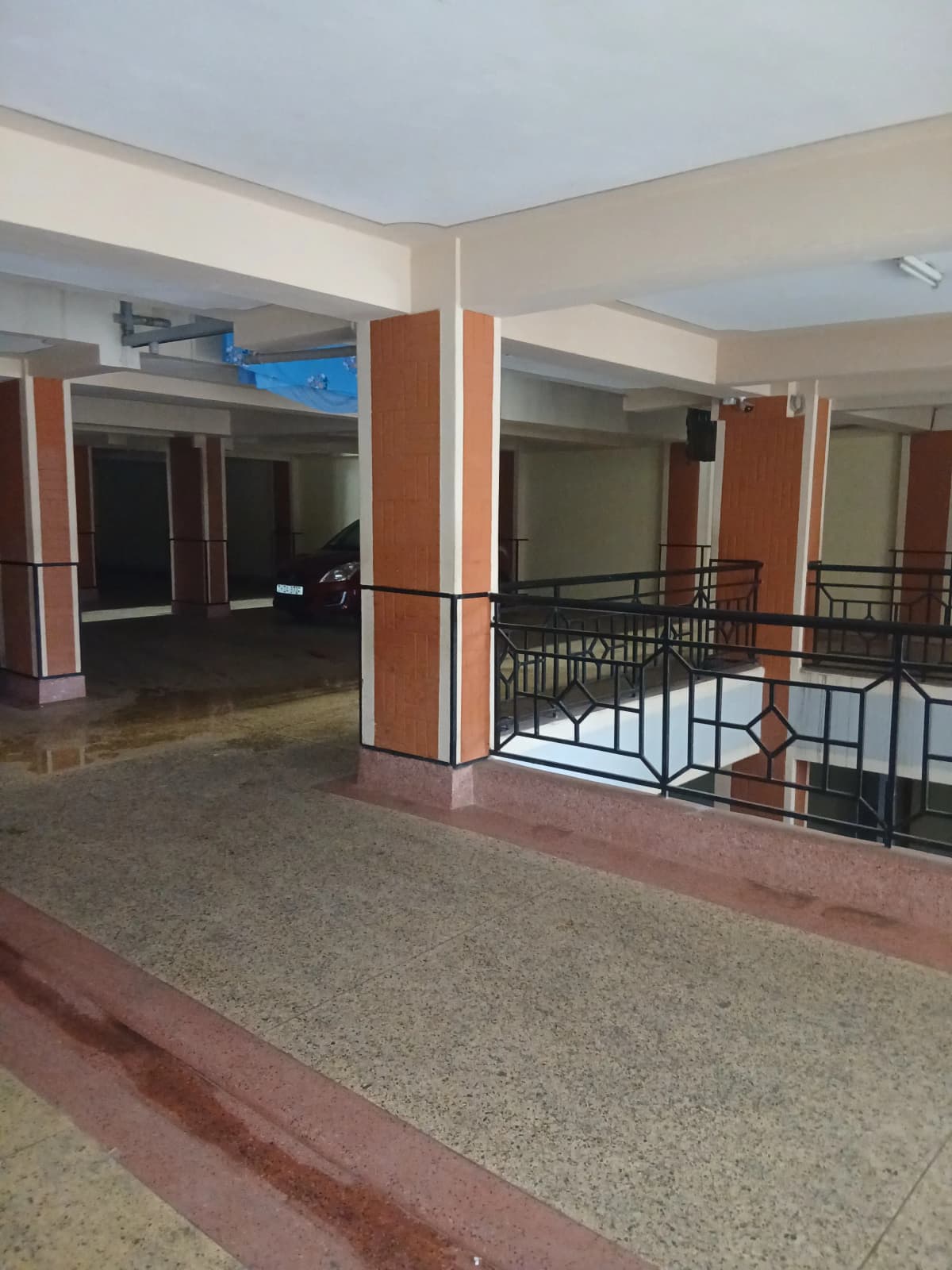 Multi-level lobby with orange pillars and metal railings