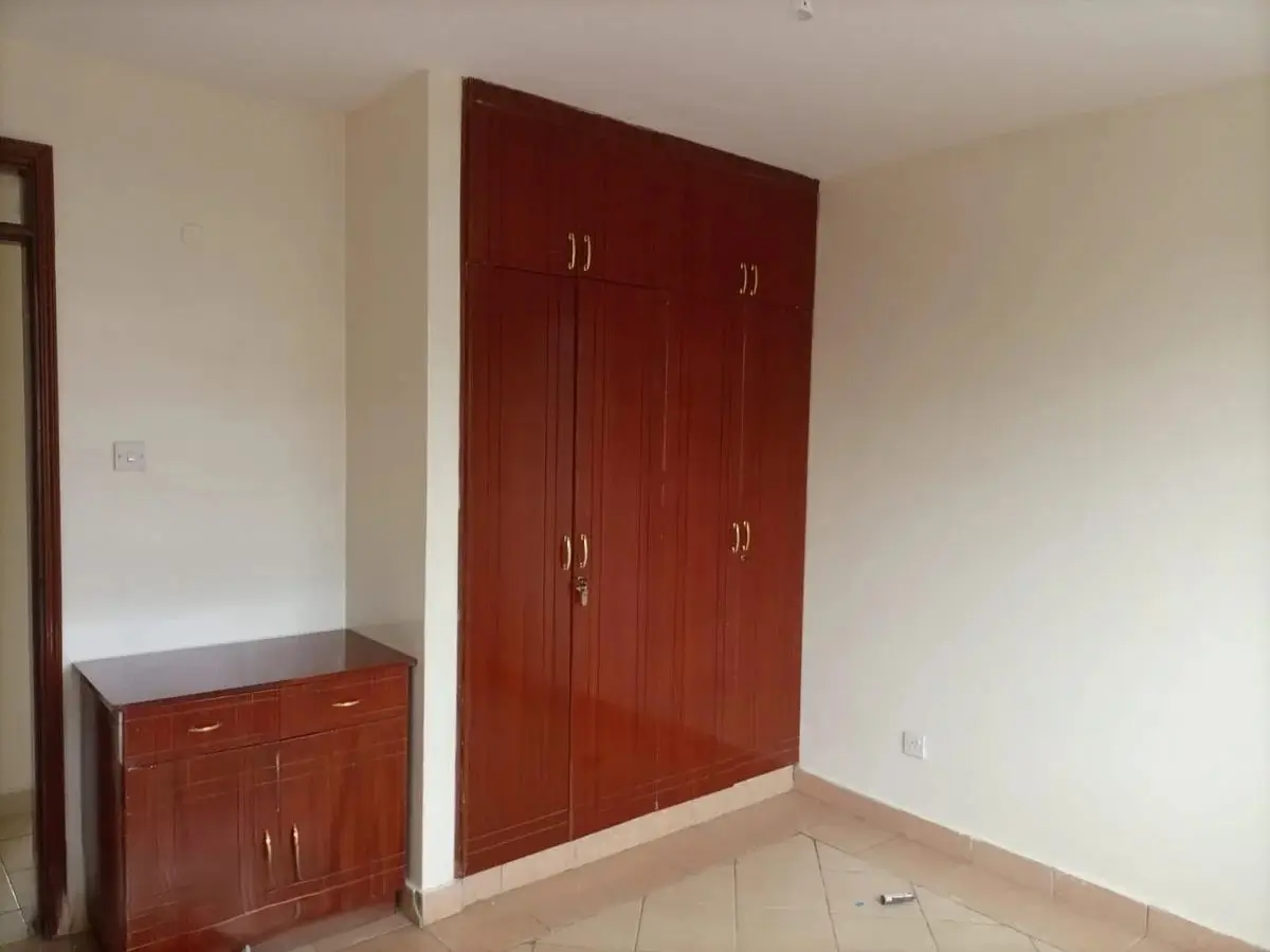 Unfurnished bedroom with large red wooden wardrobe