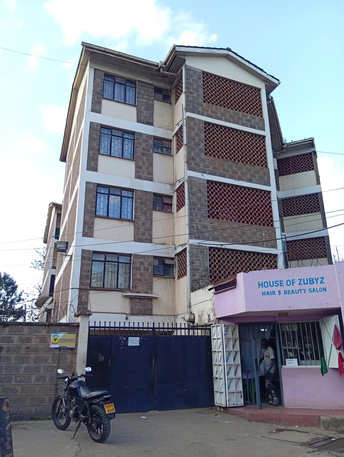Modern four-story residential building with brick and stone facade