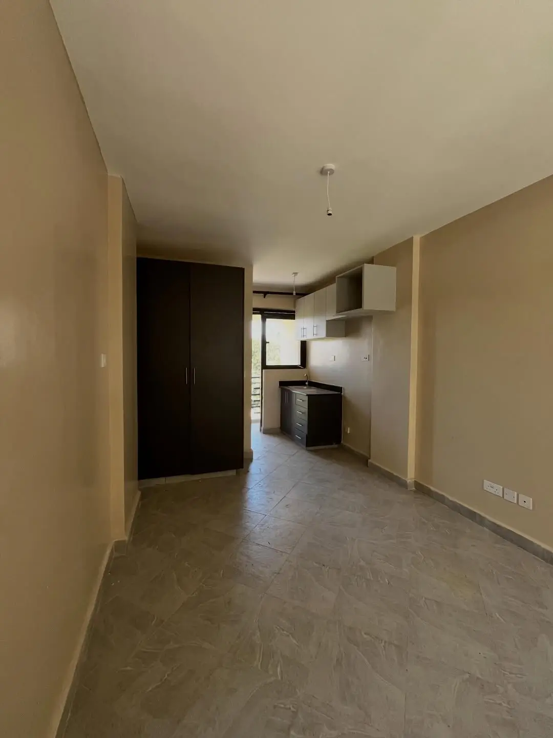 Open-plan living area with integrated kitchen visible in background