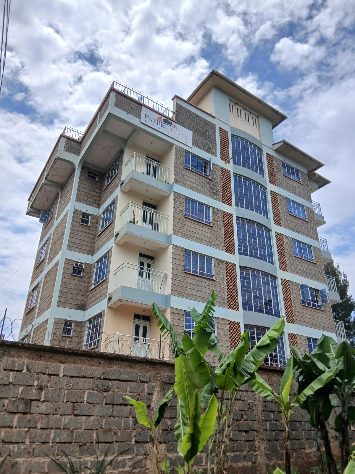 Multi-story residential apartment building with balconies and solar panels
