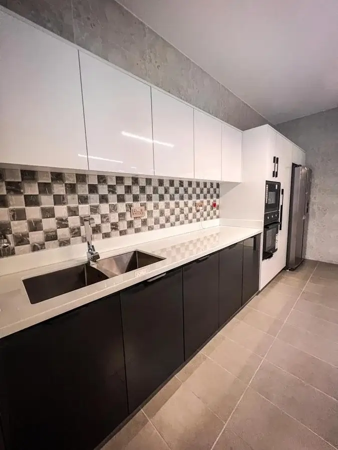 Modern kitchen with black base cabinets, checkered backtile