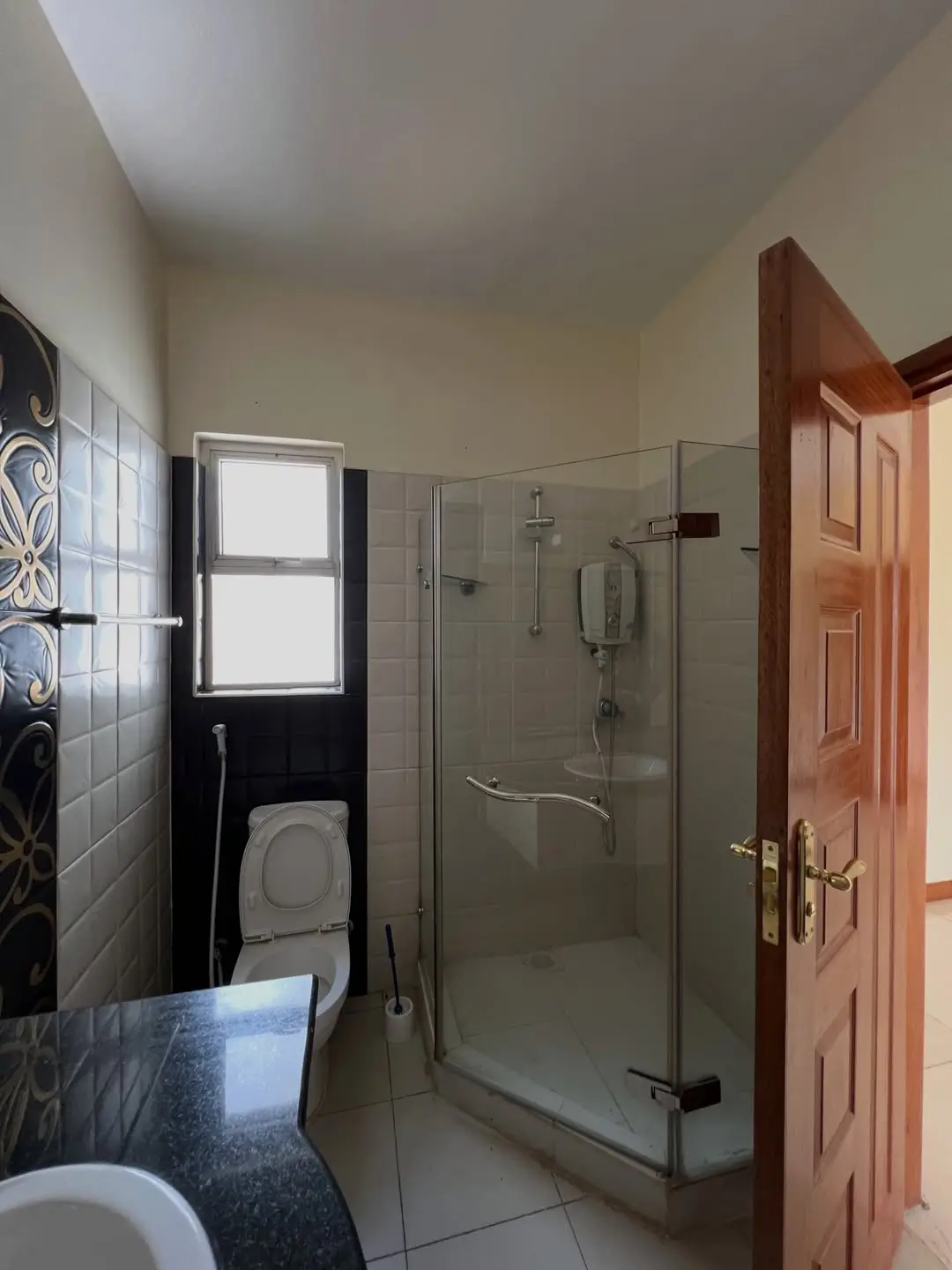 Modern bathroom with glass shower enclosure and dual vanity