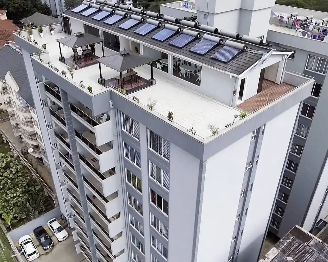 Modern apartment building with rooftop terrace and solar panels