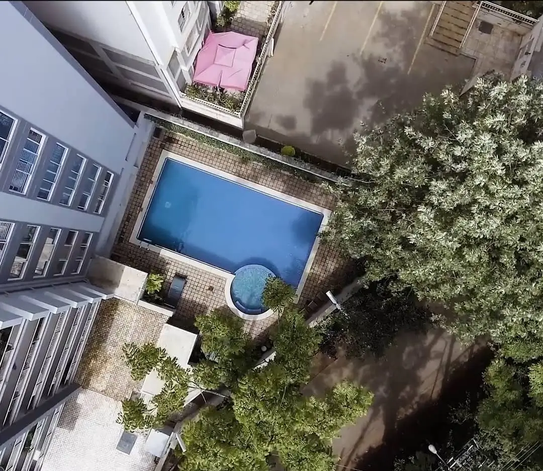 Rectangular swimming pool with jacuzzi and landscaped garden