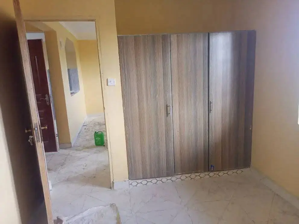 Unfurnished bedroom with built-in wooden wardrobe closets