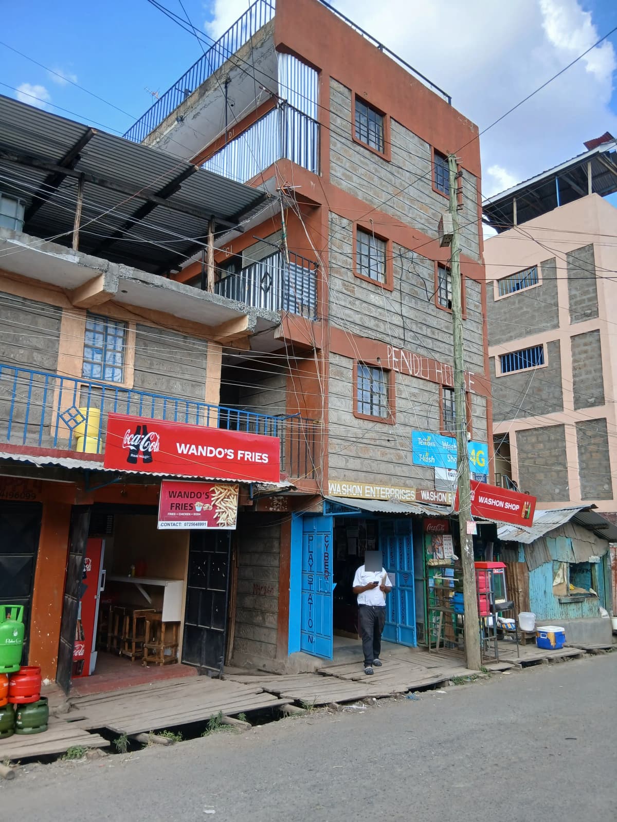 Multi-story residential building with street-level commercial shops