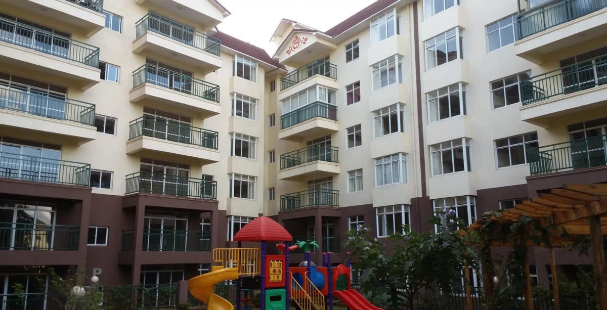 Multi-story residential building with children's play area compound