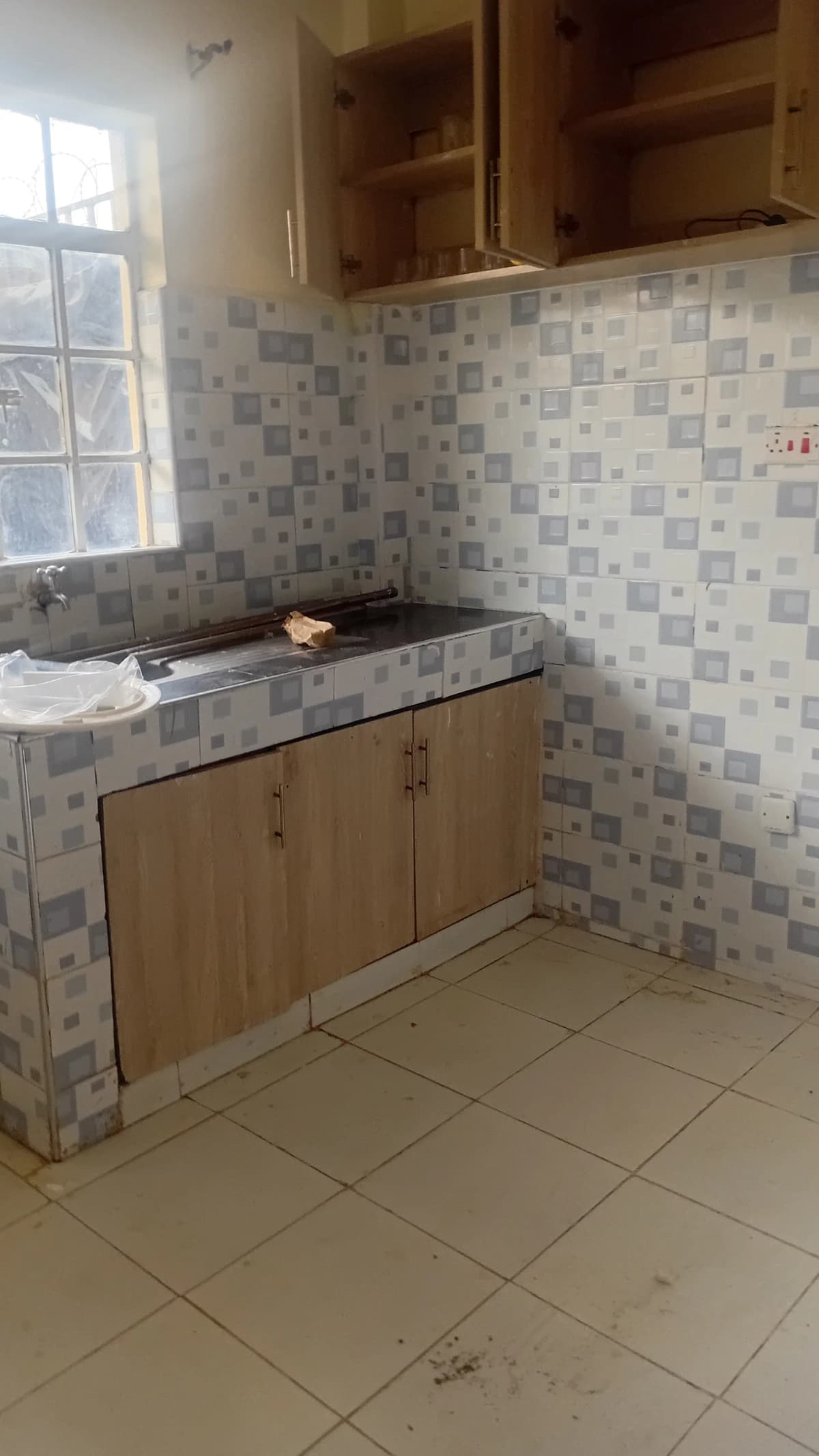 Compact kitchen with wooden cabinets and tiled backsplash